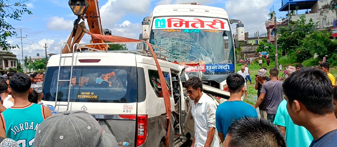 Scene of a serious collision between a passenger bus and an electric microbus at Khaharepul, Chitwan, with emergency responders and damaged vehicles on the East-West Highway.