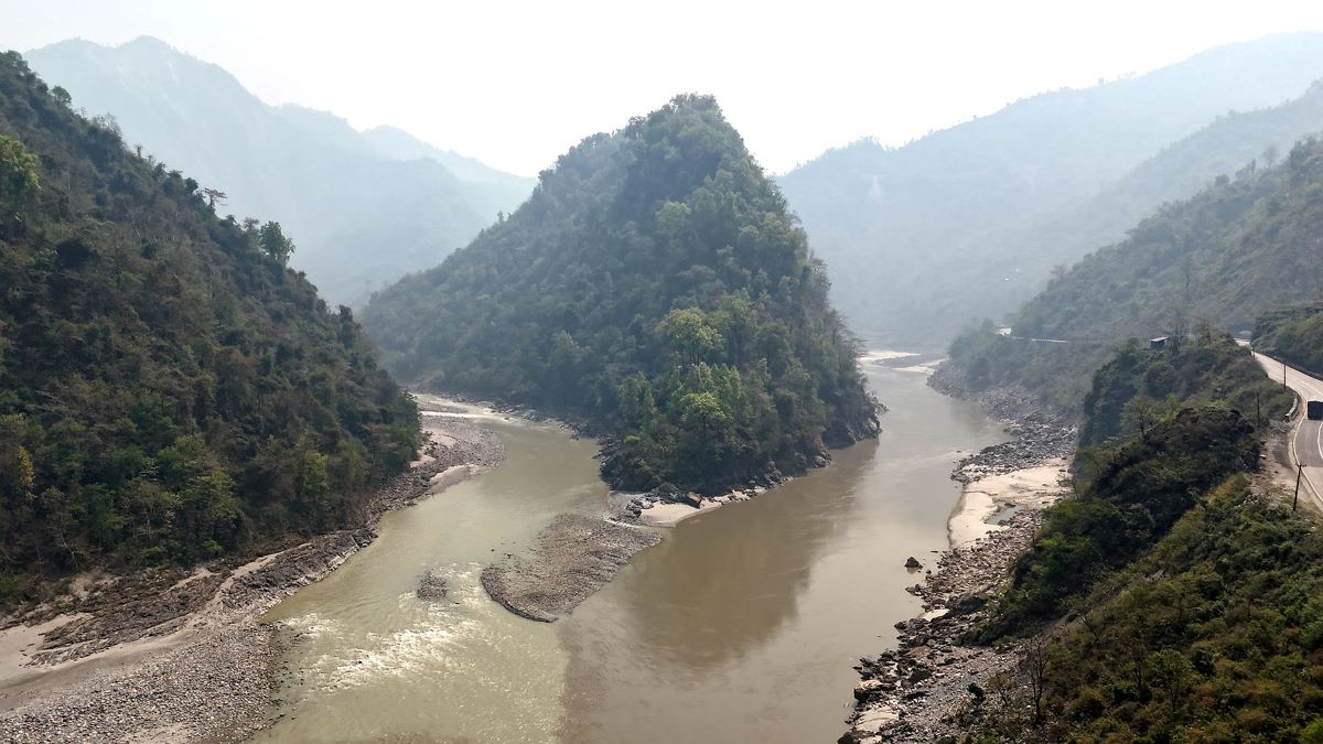 Police officers inspect the area where a male body was found along the Trishuli River in Dhading, Nepal.