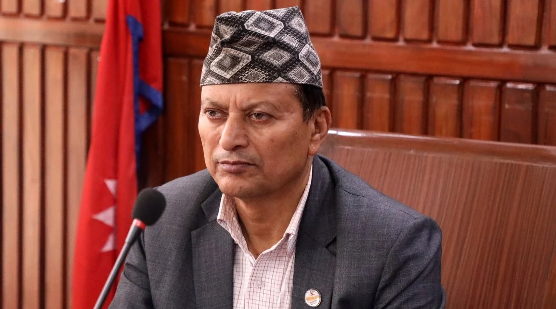Balaram Adhikari speaking at the Federal Parliament in Kathmandu amid bribery allegation discussions.