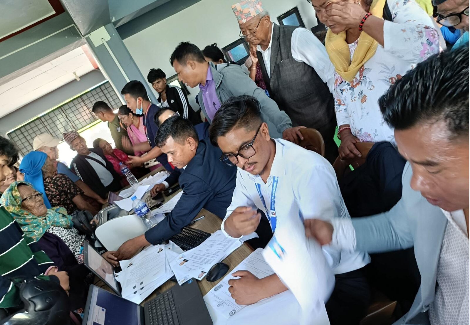 Dhawalagiri Rural Municipality officials assisting beneficiaries with social security renewal and civil services at a mobile camp in Pokhara’s Nepal Chantyal Association hall.