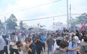 Protesters at Baneshwor in Kathmandu during the Gen Z demonstration as police use water cannons and tear gas.