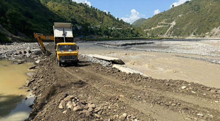 Workers construct temporary road diversions on the BP Highway to restore traffic after flood damage in Kavrepalanchok, Nepal.