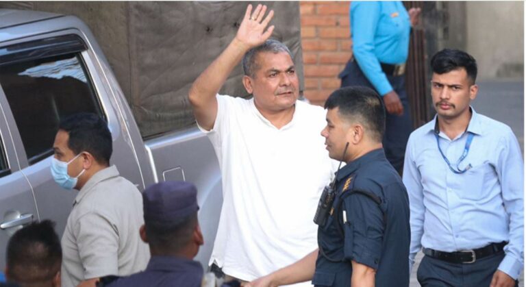 Police escorting Durga Prasai after his midnight arrest from his residence in Bhaktapur.