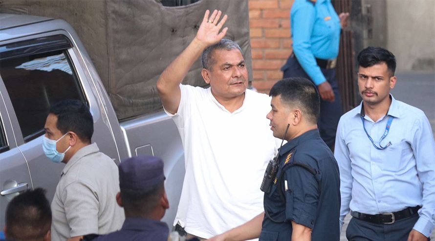 “Police escorting activist Durga Prasai after his midnight arrest in Kathmandu on charges of disturbing public order.”