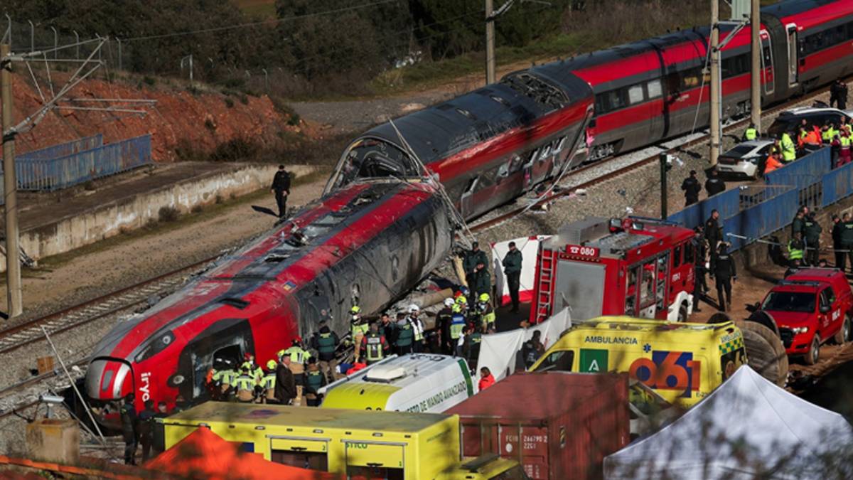 Emergency responders work near a derailed passenger train following a fatal rail accident in Spain.