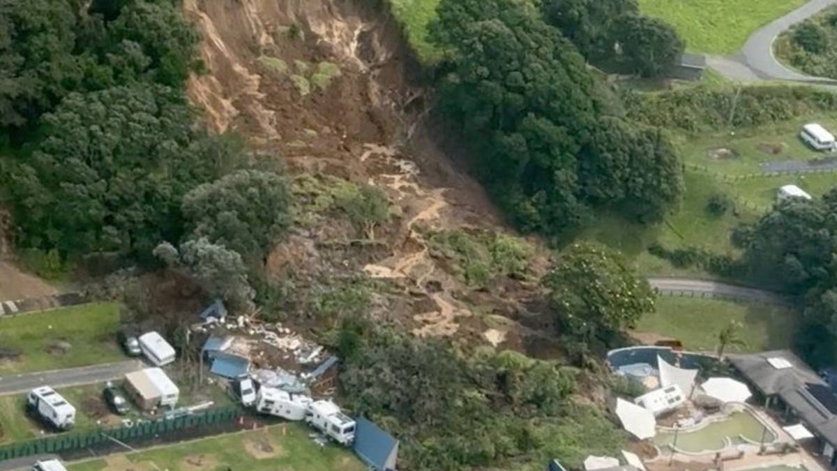 Rescue teams search through landslide debris near a campground on New Zealand’s North Island after heavy rain triggered a deadly slope collapse.