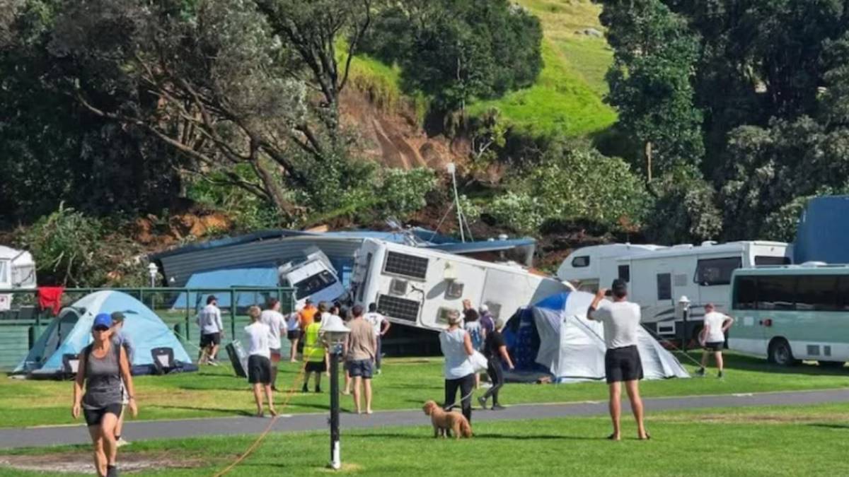 Rescue workers search through mud and debris after a landslide hit a campsite near Mount Maunganui on New Zealand’s North Island.