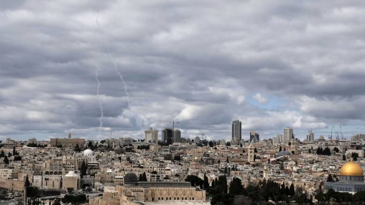 Air defense systems intercept ballistic missiles in the night sky following Israel and U.S. military strikes on Iran amid escalating Middle East tensions.