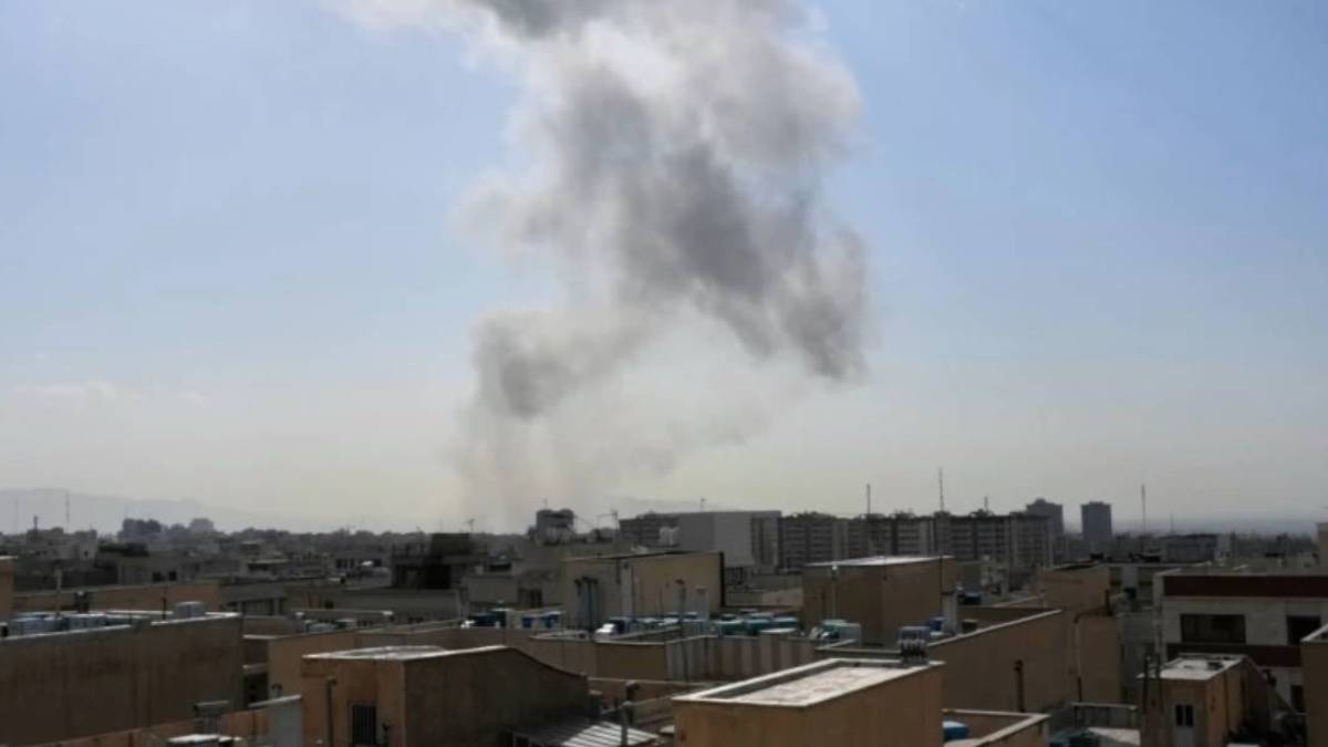 Smoke rising over central Tehran following reported explosions after Israel confirmed a military strike on Iran