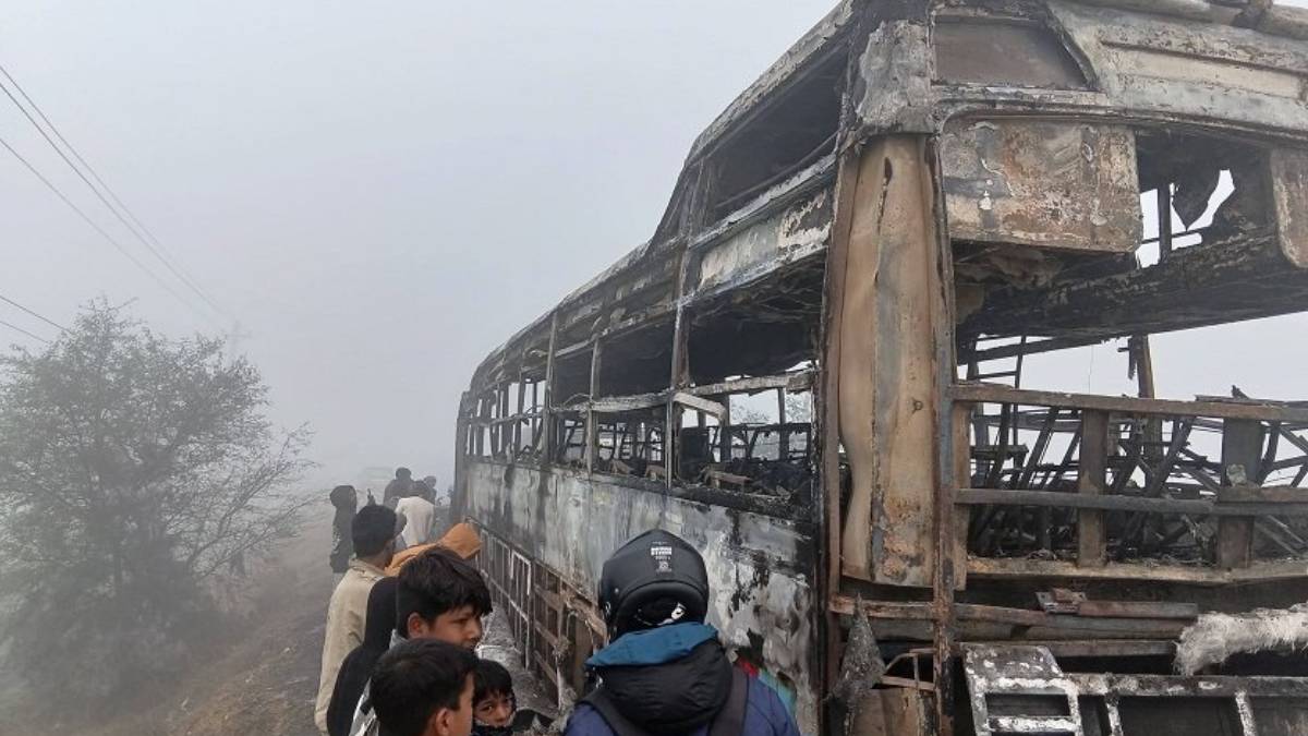 Passenger bus destroyed by fire on the Taulihawa–Bhairahawa road in Kapilvastu district as police and firefighters respond to the scene