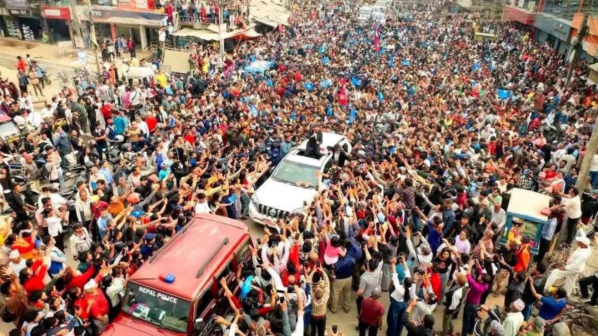 Balen Shah waves to supporters during his election campaign visit in Jhapa-5.