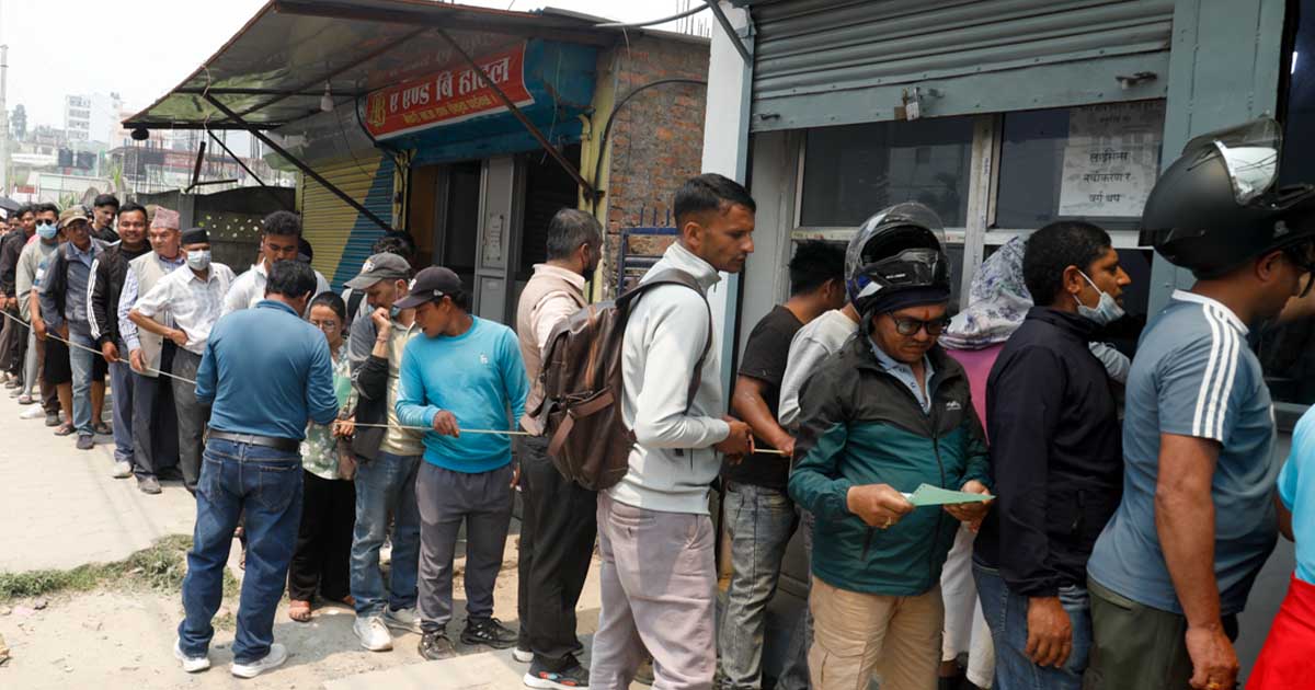People waiting in queue outside Bhaktapur Transport Office to collect driving licenses in Nepal