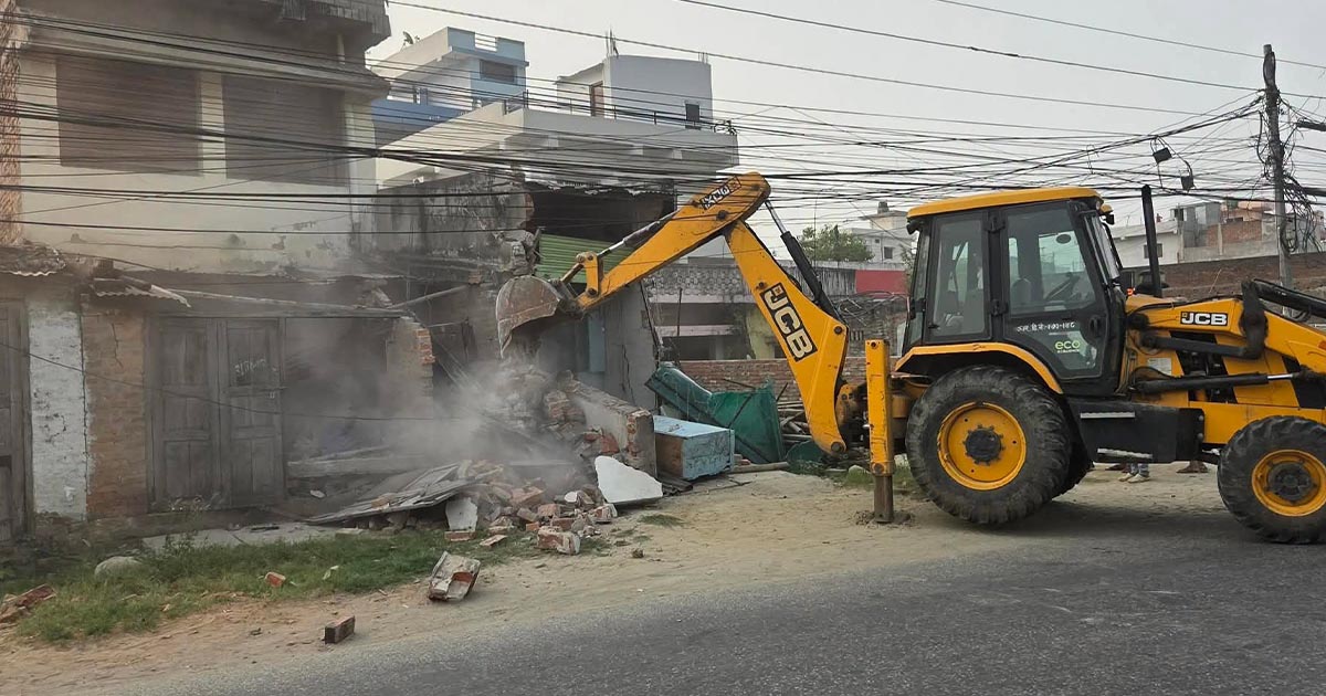 Excavator demolishing a house in Birgunj during road expansion, Nepal 2026