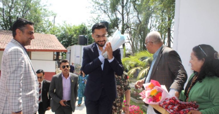Education Minister welcomed during visit to Janak Education Materials Centre in Nepal with officials and staff