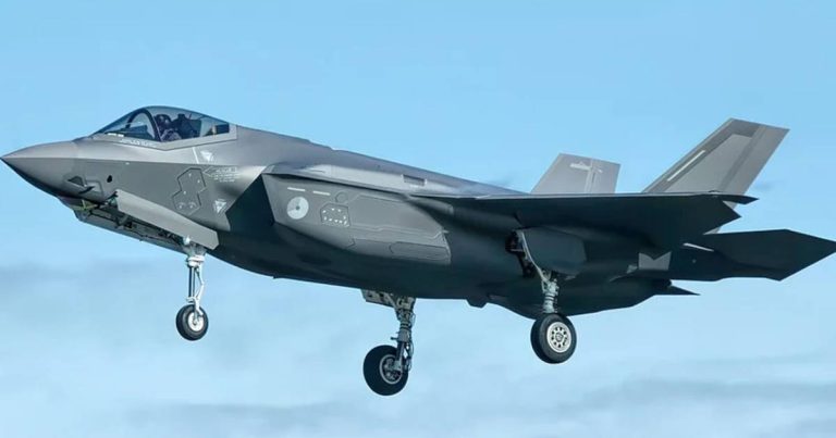 US F-35 stealth fighter jet flying with landing gear deployed during operation