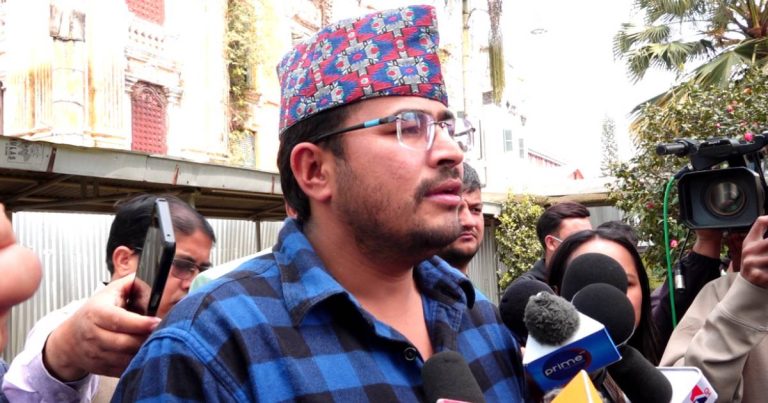 Gyanendra Shahi speaking to reporters surrounded by microphones in Kathmandu