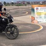 Person taking motorcycle driving test in Nepal with driving licence card showing new 24 hour service