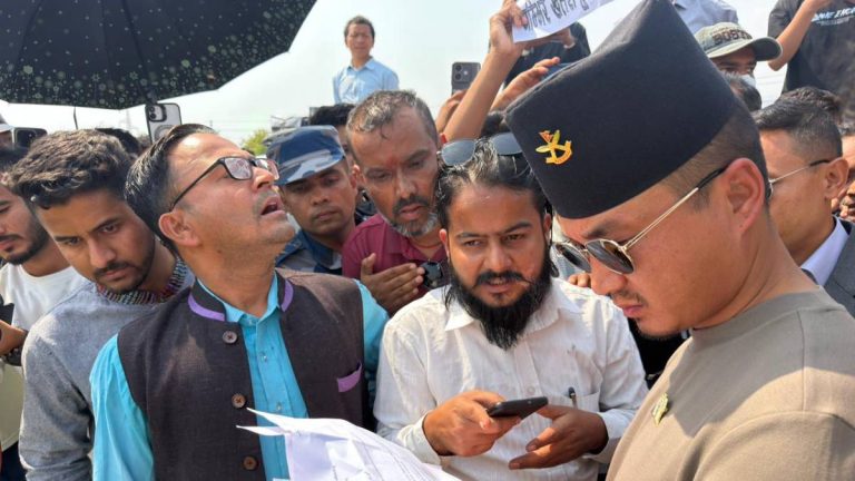 Group of men surrounding Home Minister Gurung as a petition is handed over during a public gathering in Nawalpur
