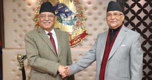 Prachanda and KP Oli shaking hands during a political meeting in Nepal file photo