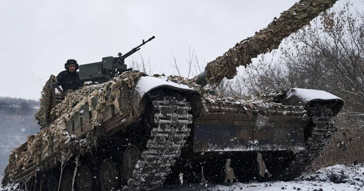 Russian tank with camouflage moves through snowy battlefield during Ukraine war as tensions rise over foreign fighters