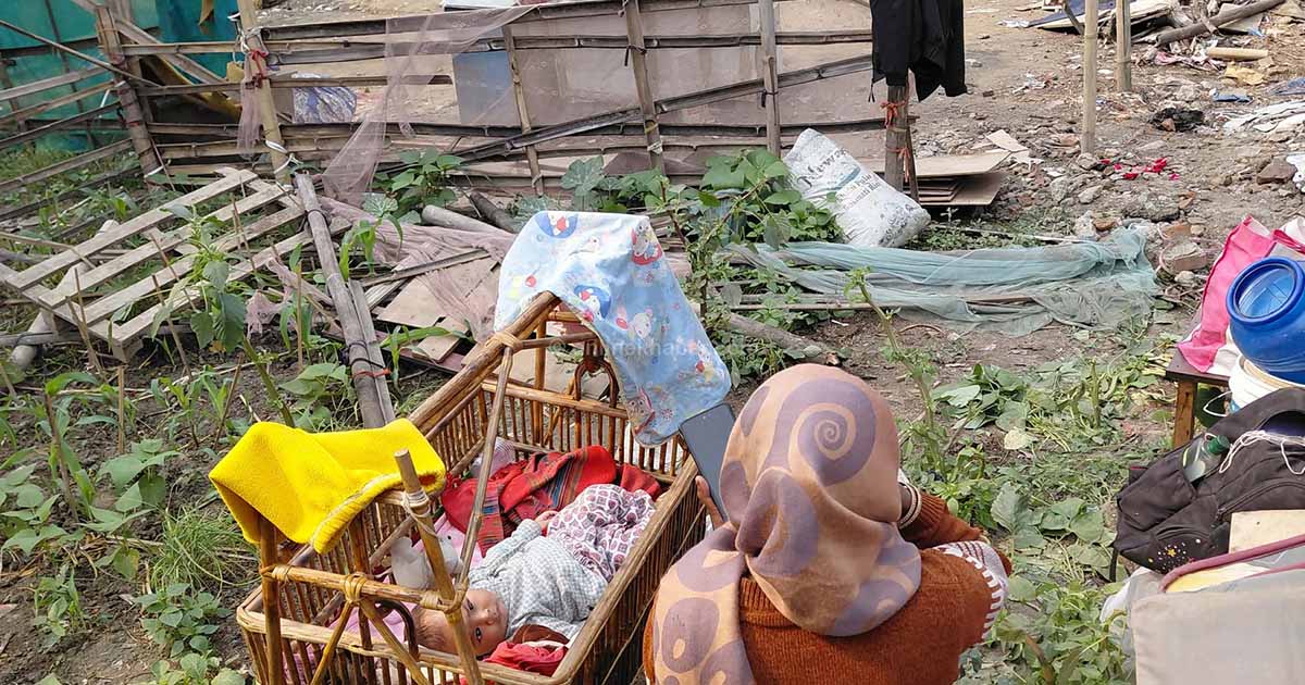 Sukumbasi mother sitting roadside with child after Thapathali eviction in Kathmandu Nepal
