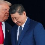 Donald Trump speaks closely with Xi Jinping during a meeting amid tensions over Iran arms and satellite claims