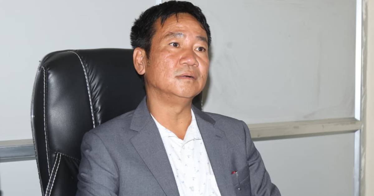 Harka Sampang seated in an office speaking during meeting invitation dispute