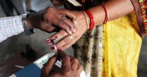 Election staff applying indelible ink on a voter’s finger during panchayat polling in Himachal Pradesh