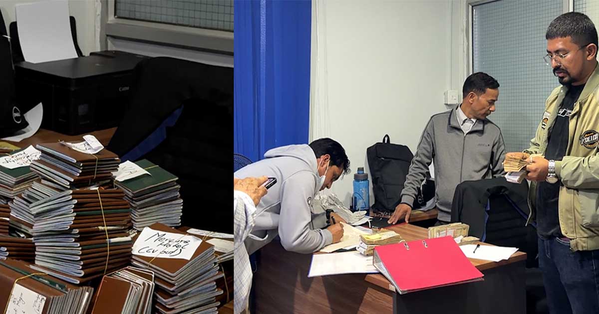 Officials inspect seized passports during a manpower raid in Lalitpur