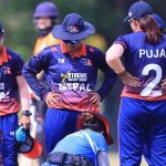 Nepal women's cricket players gather on the field during a match in Malaysia