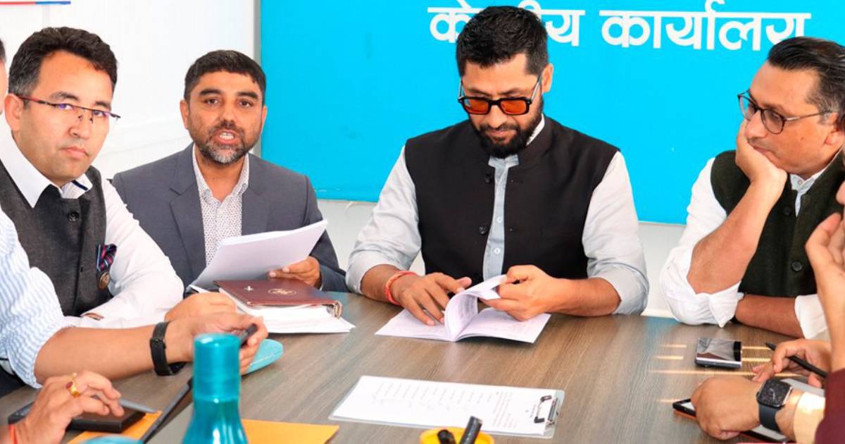 Leaders attend Rastriya Swatantra Party secretariat meeting discussing documents at office table