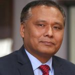 Portrait of Kulman Ghising in a suit and red tie during an official appearance