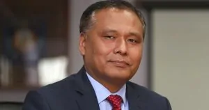 Portrait of Kulman Ghising in a suit and red tie during an official appearance