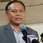 Kulman Ghising speaks into a microphone during a media briefing