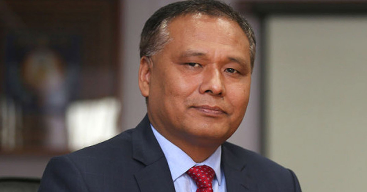 Portrait of Kulman Ghising in a suit and red tie during an official appearance