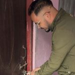 A man locking the door of the RSP district office in Dailekh during a party dispute