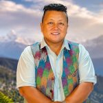 Sharin Tamang posing outdoors with a mountain landscape in the background