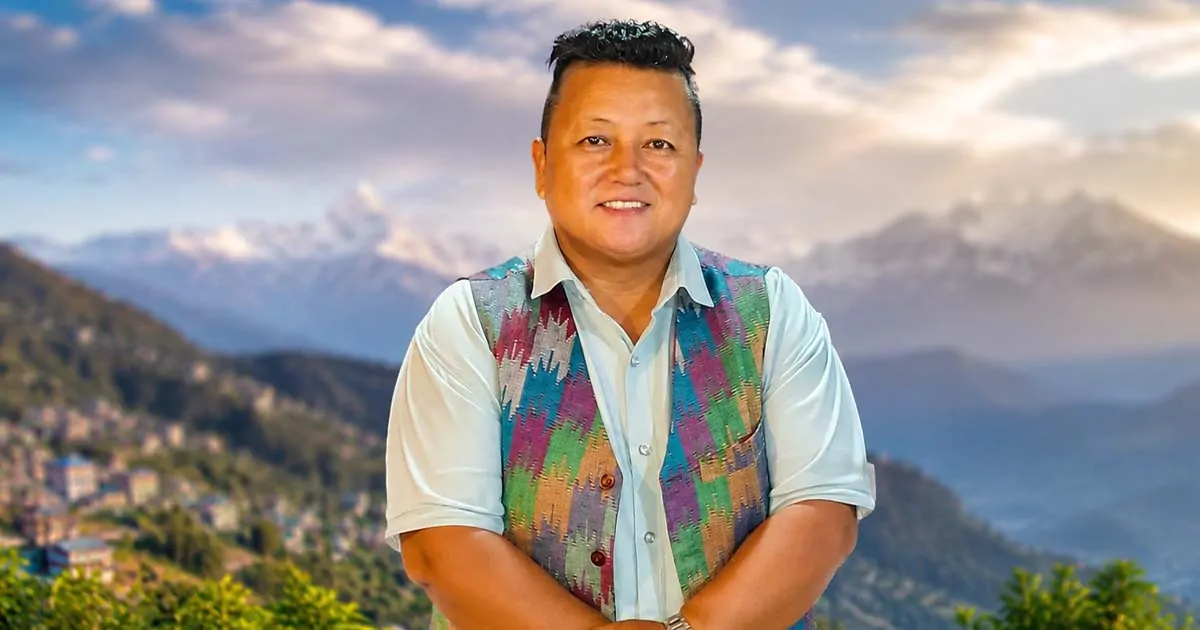 Sharin Tamang posing outdoors with a mountain landscape in the background