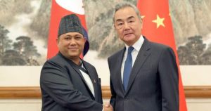 Nepal Foreign Minister Shishir Khanal shakes hands with Chinese Foreign Minister Wang Yi in Beijing