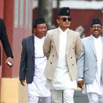 Sudan Gurung walks with fellow leaders inside a government complex in Kathmandu