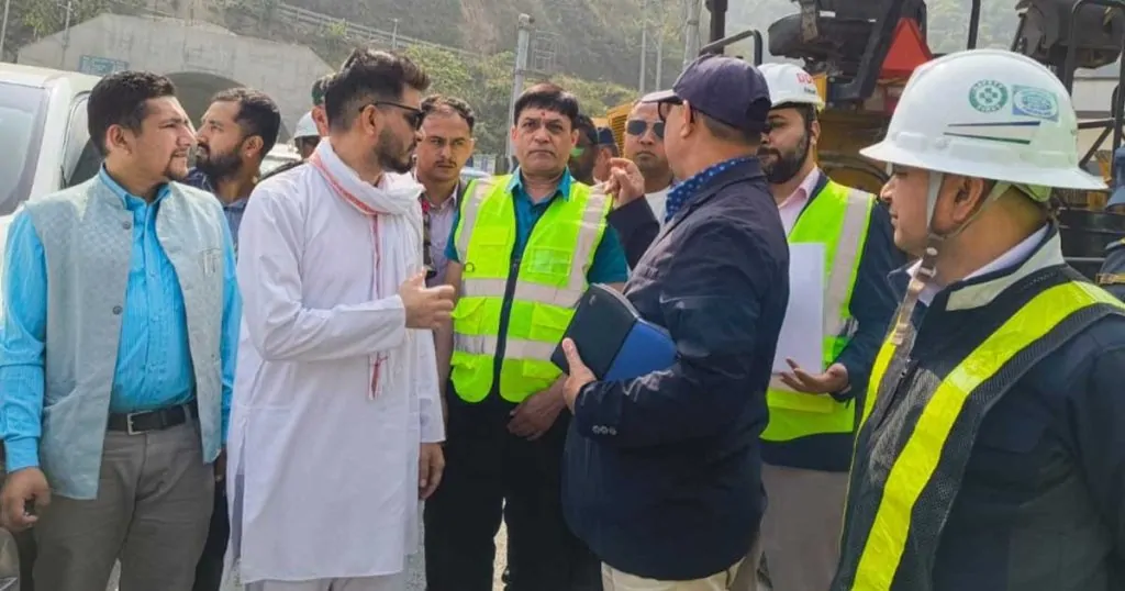 Minister Sunil Lamsal speaks with officials and engineers during a road project inspection