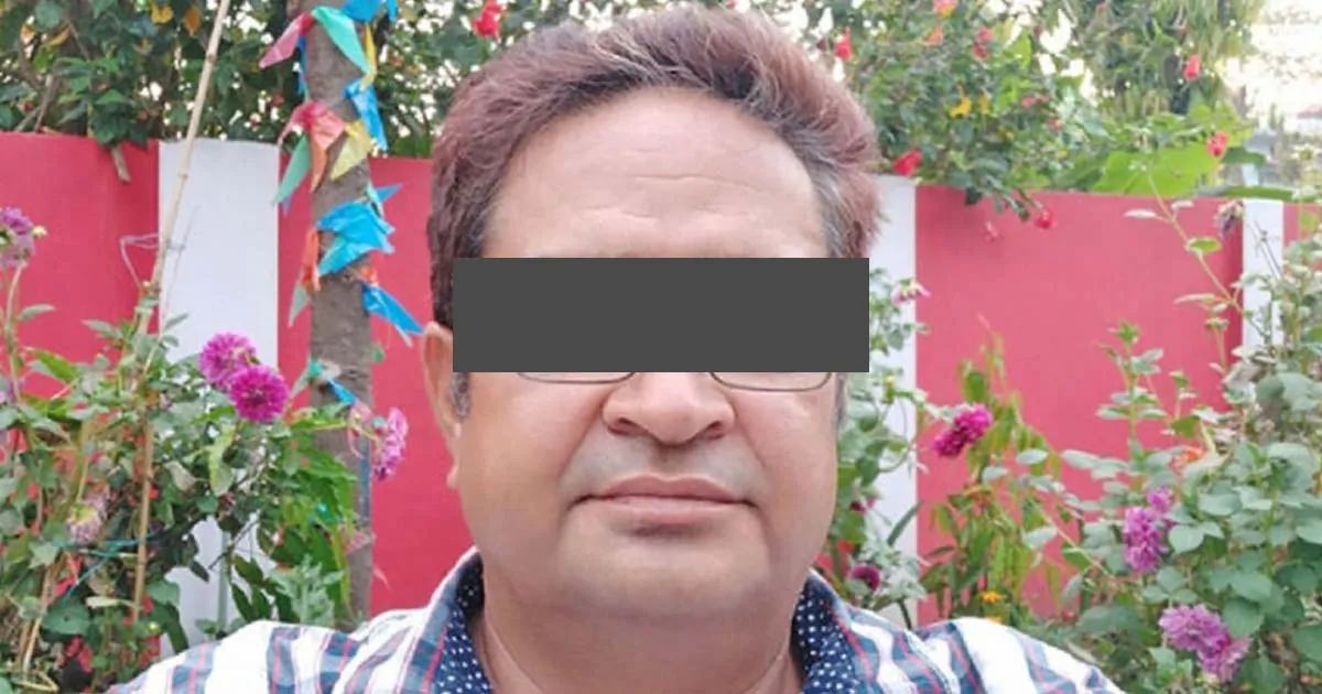 Portrait of journalist Khem Bhandari outdoors with a garden in the background.